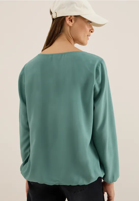 Elegante einfarbige grüne Bluse mit Cut-Out