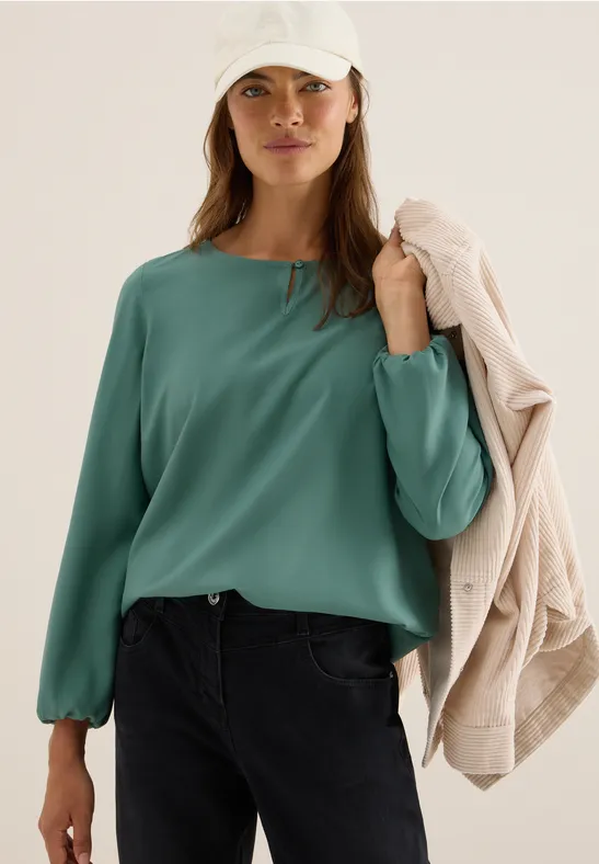 Elegante einfarbige grüne Bluse mit Cut-Out