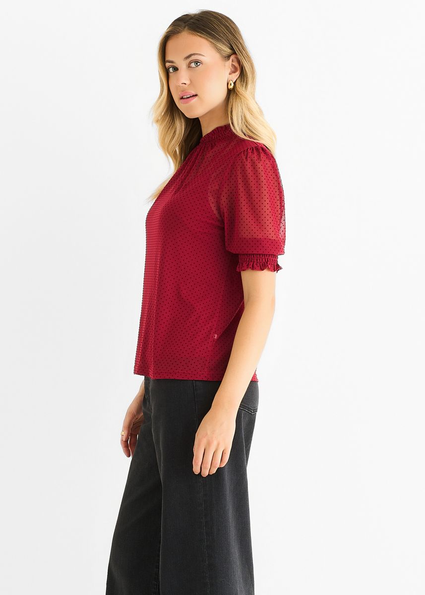 Gepunktete Bluse mit hohem Kragen